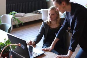 A top executive explaining job details to an executive assistant